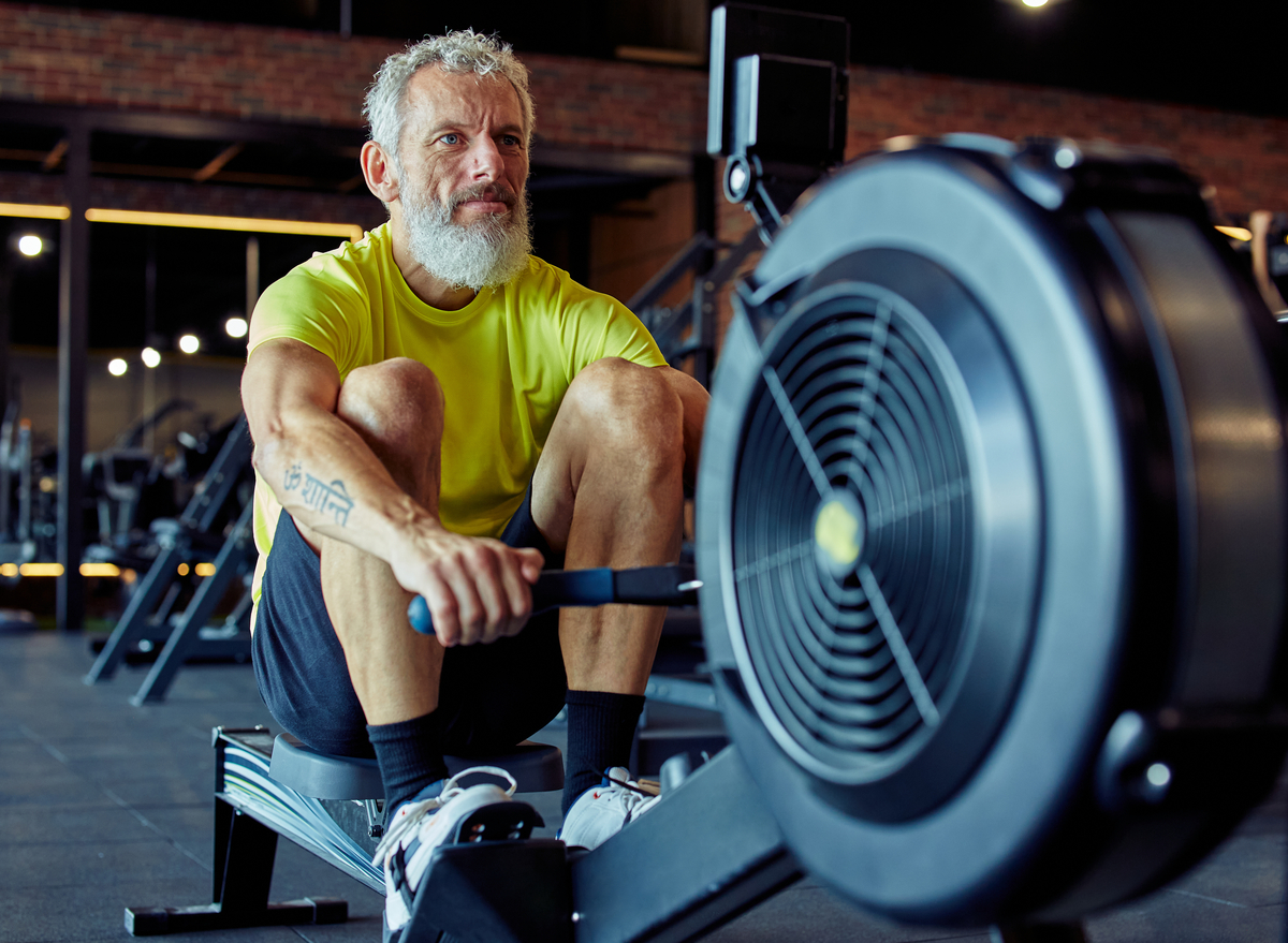 older man rowing machine