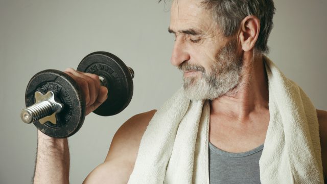 older man working out gym weights