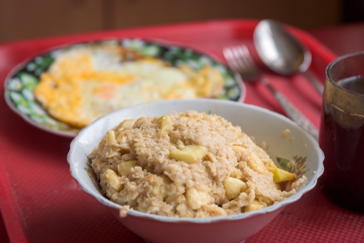 scrambled eggs and oatmeal on red tray