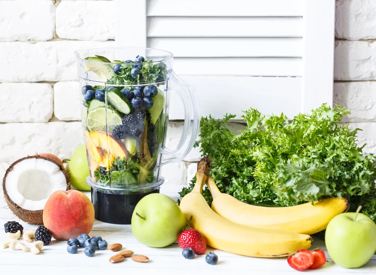 blender with variety of fruits and vegetables for a smoothie