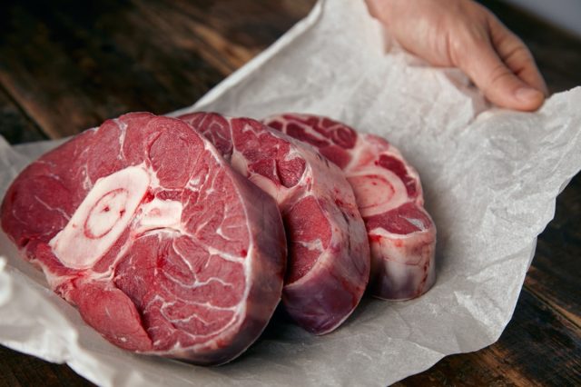 three bone-in steaks on white paper