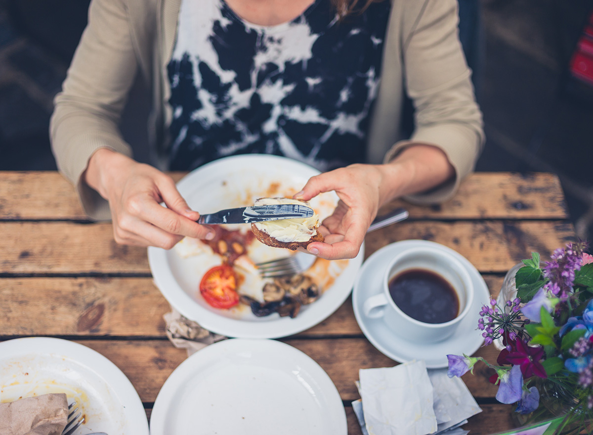 A,Young,Woman,Is,Having,A,Traditional,English,Breakfast,In
