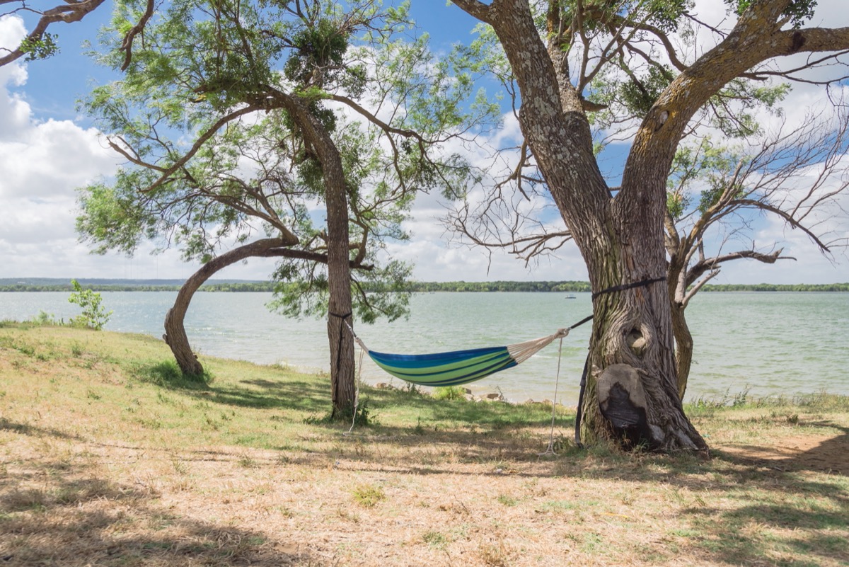 hammock hanging between two trees on a beach in grand prairie, texas