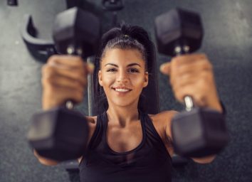 happy woman smiling gym weights