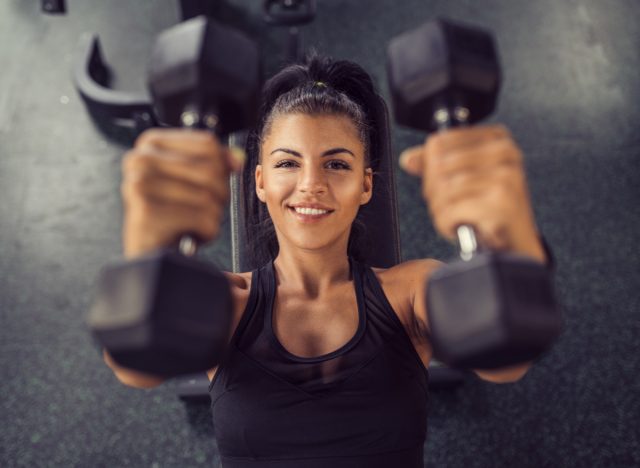 happy smiling woman weights gym