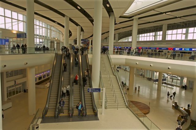 travelers walking through louis armstrong new orleans international airport