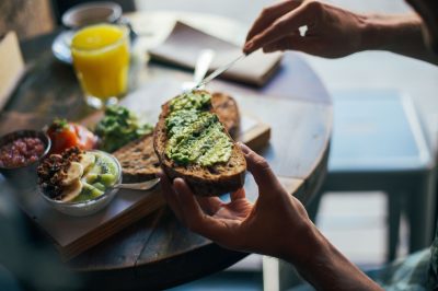 person making avocado toast