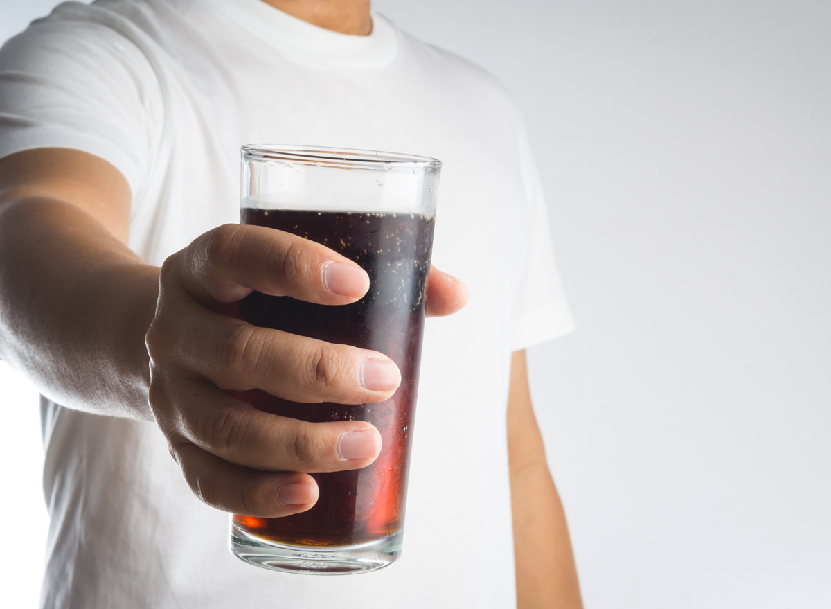 man holding soda