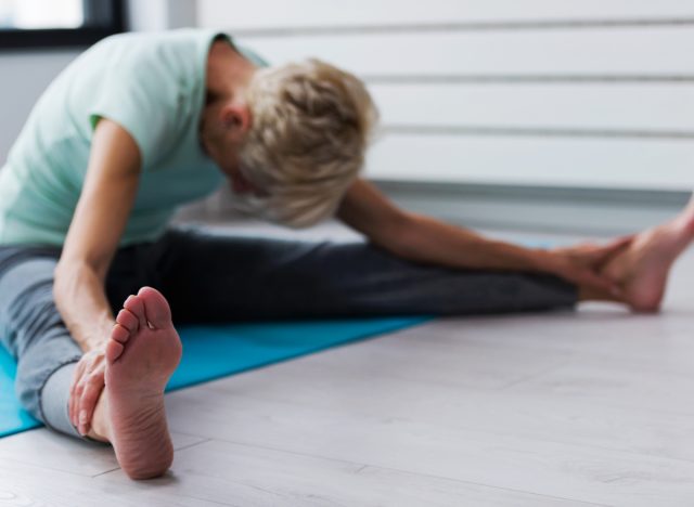 older woman stretching yoga