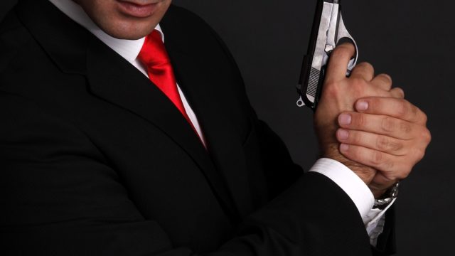 Handsome man with gun elegant spy.