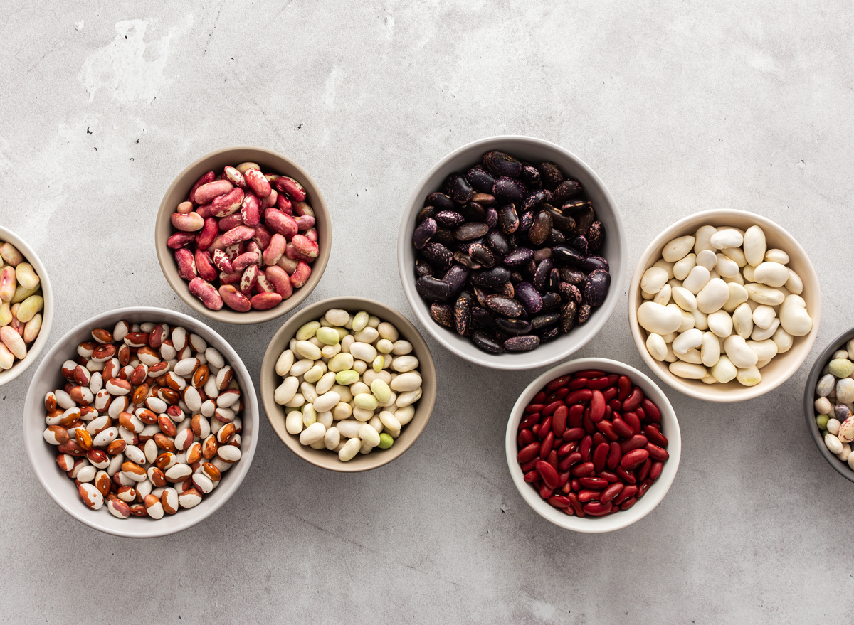Different types of beans in bowls, economically important legume, top view