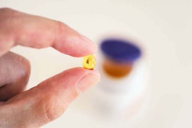 Vitamin D capsule in a hand