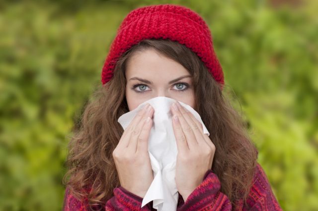 Woman outdoor with cold and handkerchief