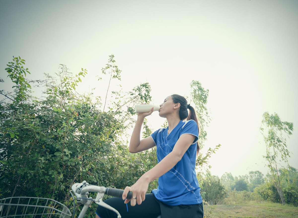 Girl drinking water outside