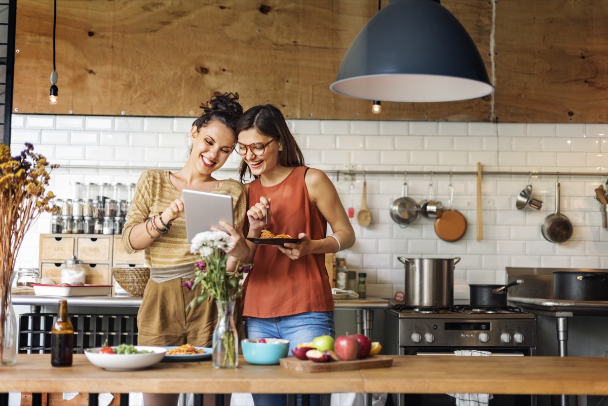 two young women making a meal together