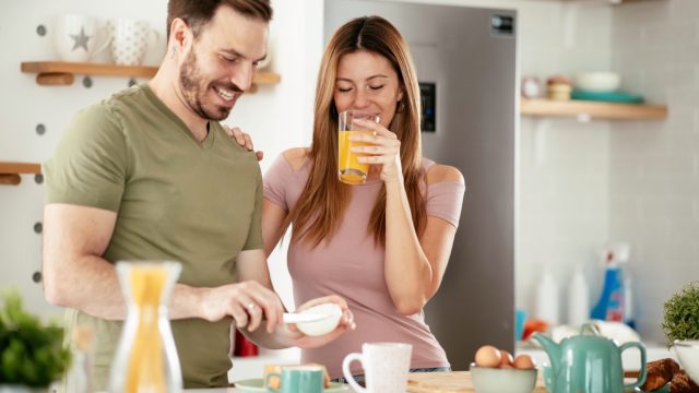 young couple making breakfast together