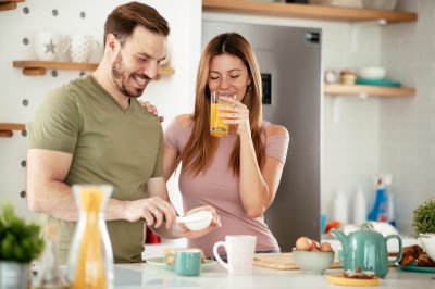 young couple making breakfast together