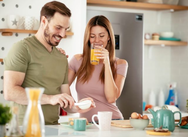 young couple making breakfast together