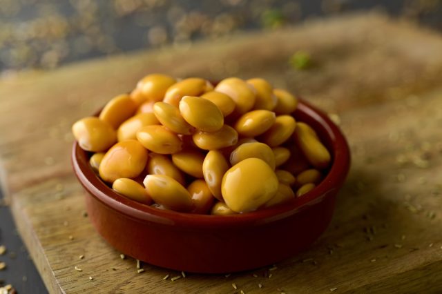 lupini beans in brown or maroon bowl