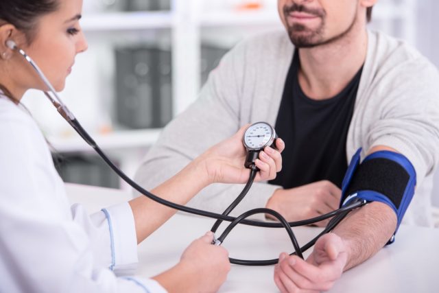 man having blood pressure checked