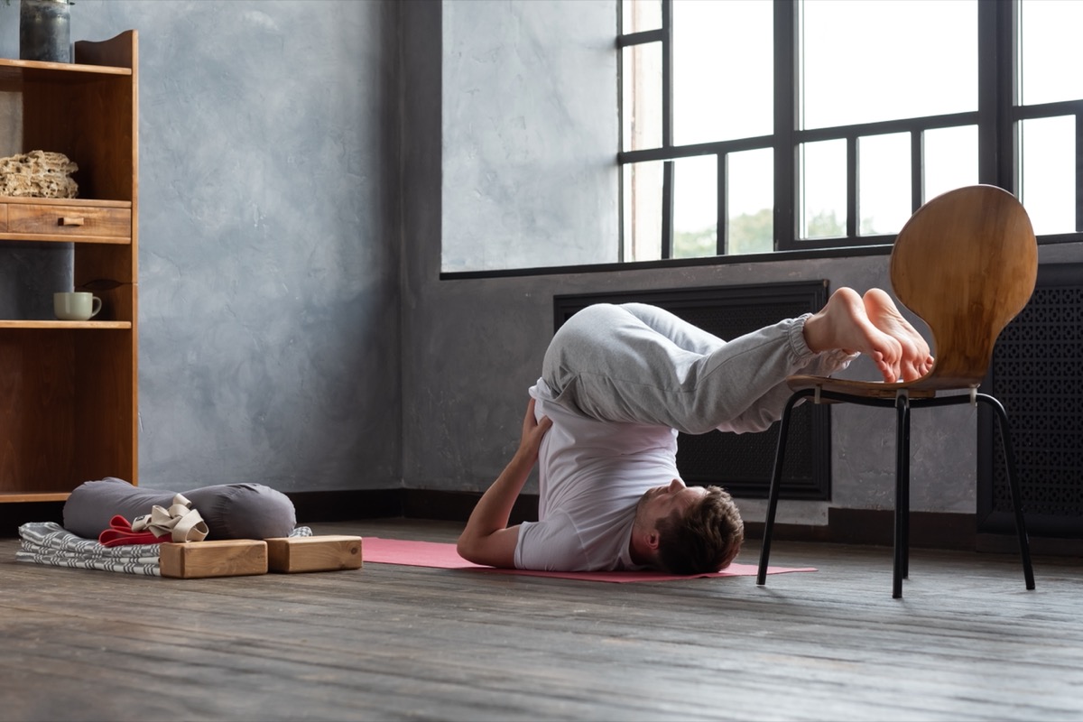 middle aged man doing plow pose