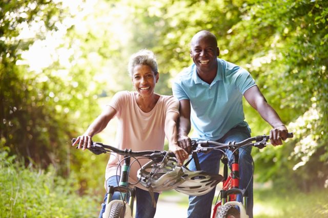 middle aged couple biking