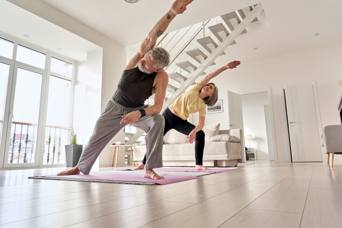 older couple exercising in modern home