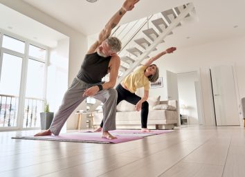 older couple exercising in modern home