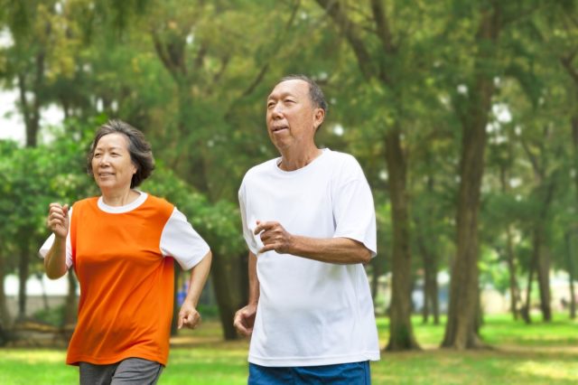 middle aged couple running outdoors