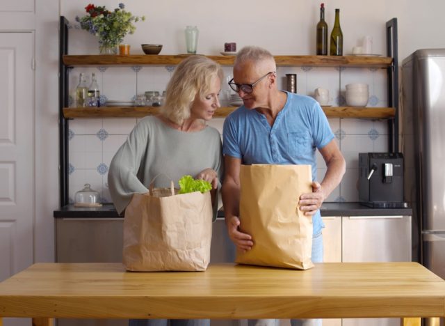 older couple unpacking groceries at home