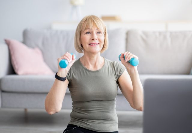 senior woman doing dumbbell training at home