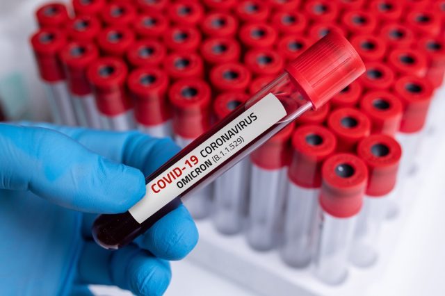 Doctor with blood sample of Covid-19 Omicron B.1.1.529 Variant and general data of covid-19 Coronavirus Mutations.