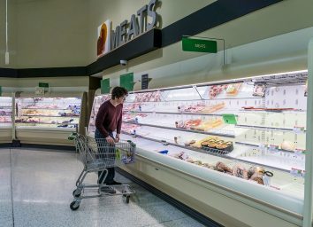 man standing in publix meat aisle with empty shelves