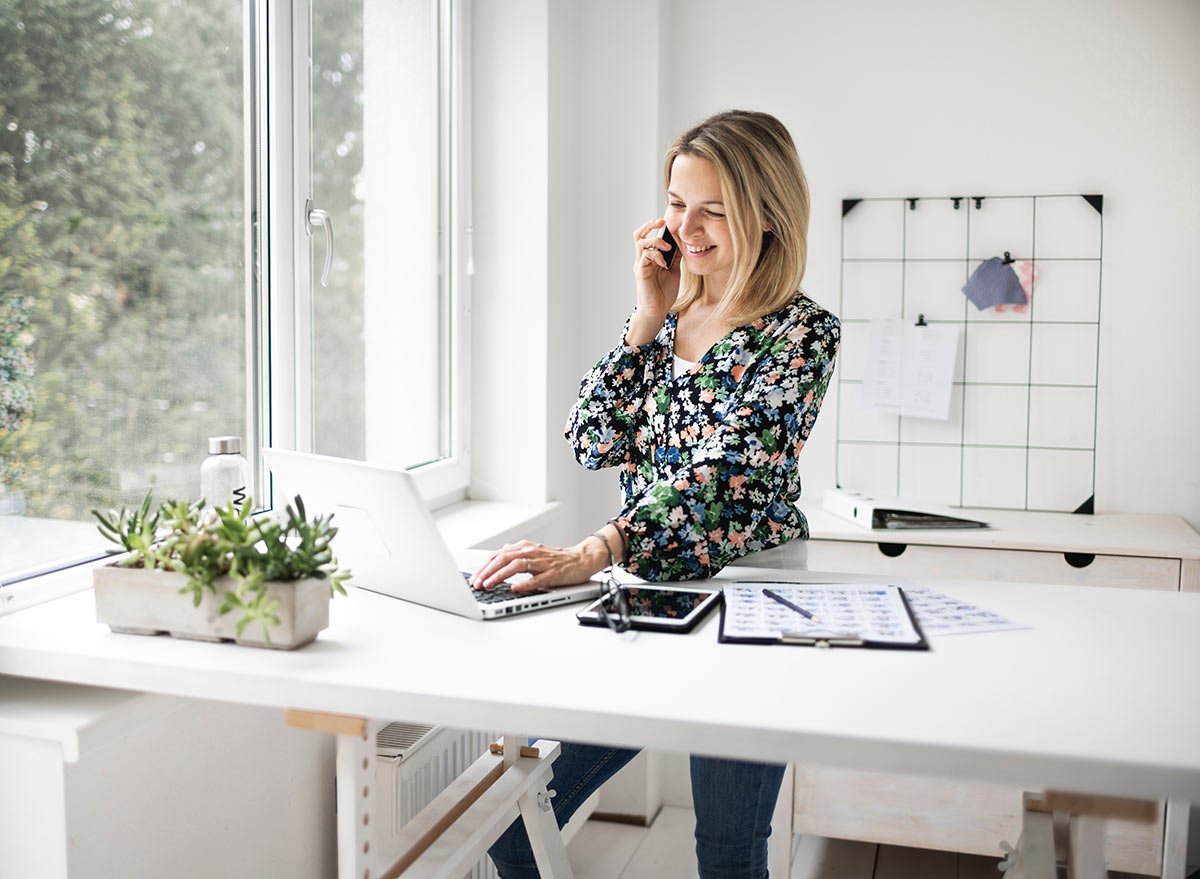 woman at standing desk on the phone