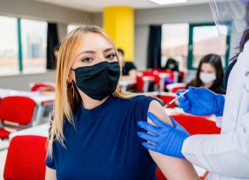 Nurse gives students a vaccination in school during coronavirus pandemic