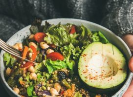 cropped-woman-holding-bowl-salad-avocado-grains-beans-veggies-1.jpg
