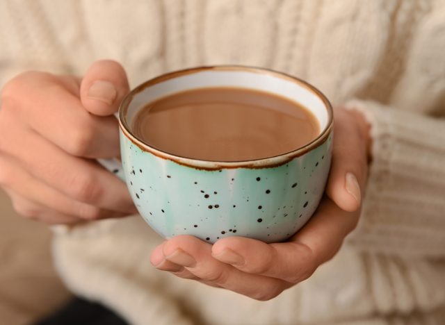 holding a mug of hot cocoa