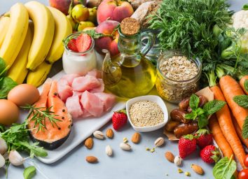 Assortment of healthy food ingredients for cooking on a kitchen table.