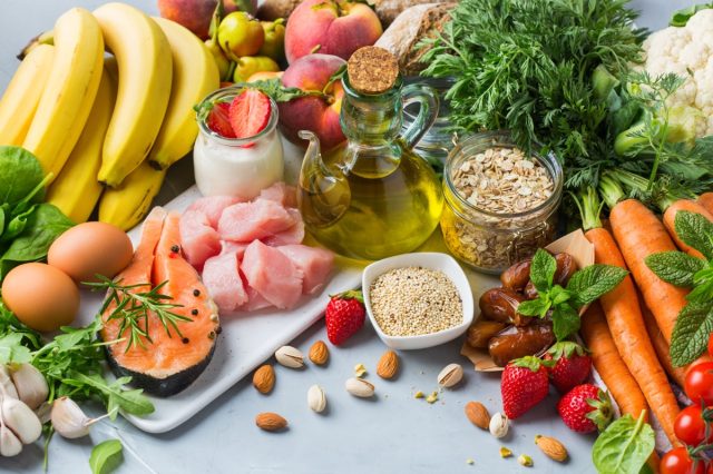 Assortment of healthy food ingredients for cooking on a kitchen table.