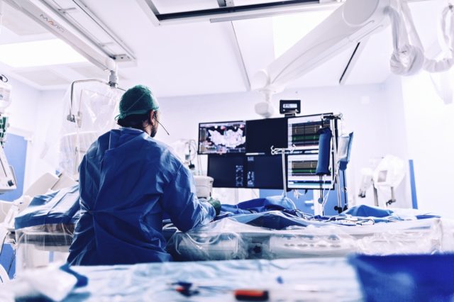 Cardiologist doing catheter ablation with radiofrequency energy using imaging system with fluoroscopic X-ray tube for interventional vascular procedures and electrophysiology. image guided system