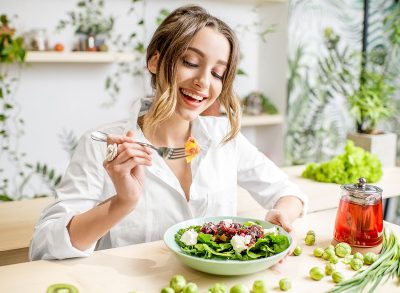 happy woman eating a healthy salad