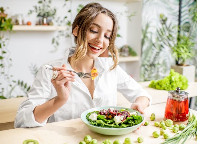 Happy woman eating a healthy salad