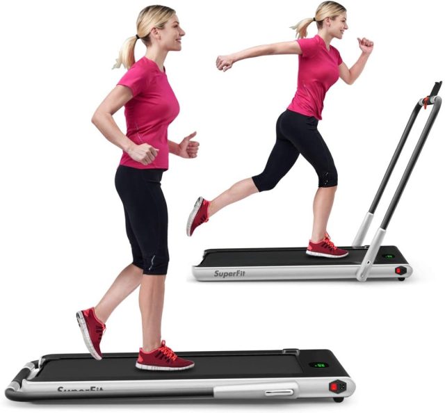 woman in pink top and black leggings running on treadmill on white background