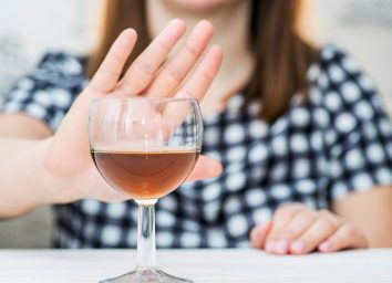 woman refusing glass of alcohol