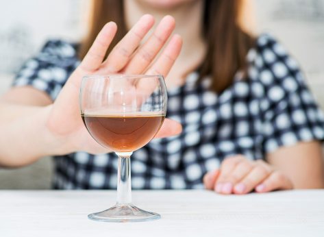 woman refusing glass of alcohol