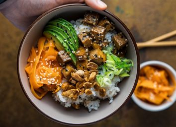 holding a vegan tofu sushi bowl