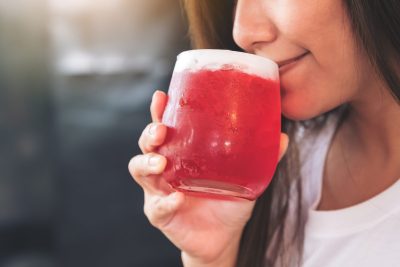 woman drinking sugary beverage