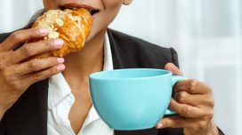 woman eating croissant