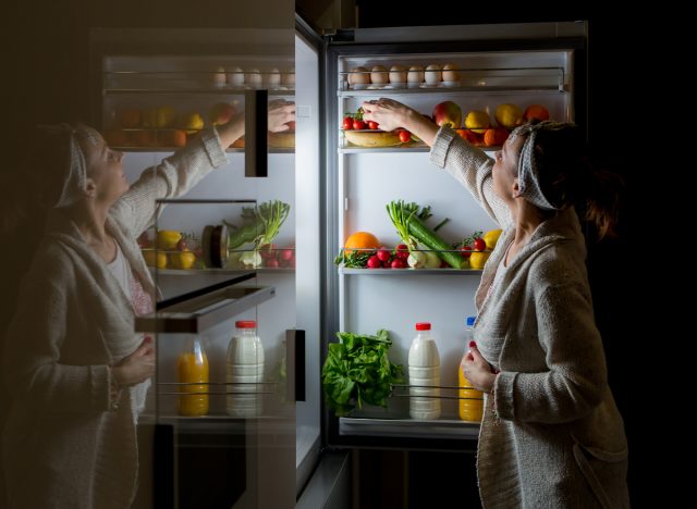 woman getting food at night