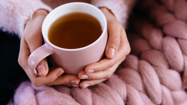 The Best Drinks to Shrink Visceral Fat, Says Dietitian 1 woman holding tea